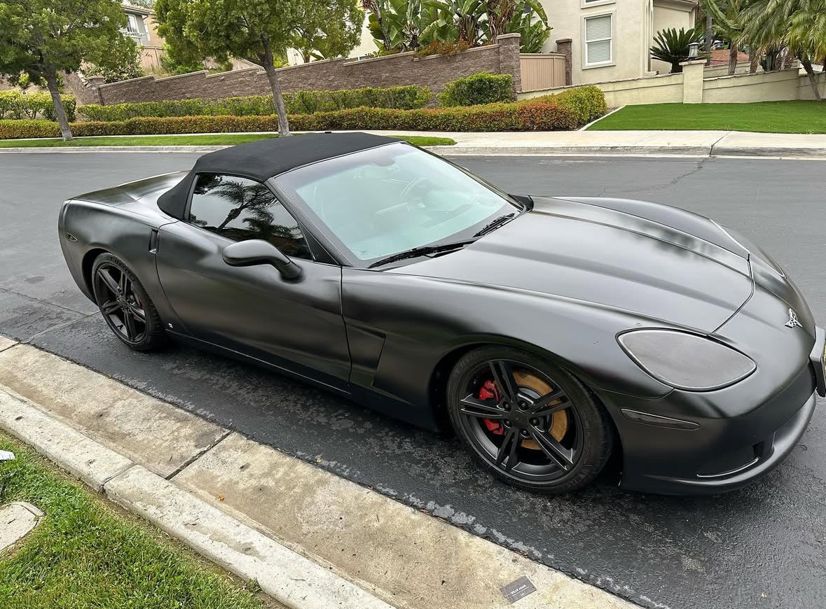 Gray convertible sports car parked on a residential street